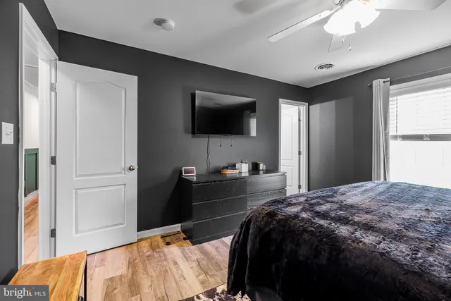 a bedroom with a bed and a flat tv screen