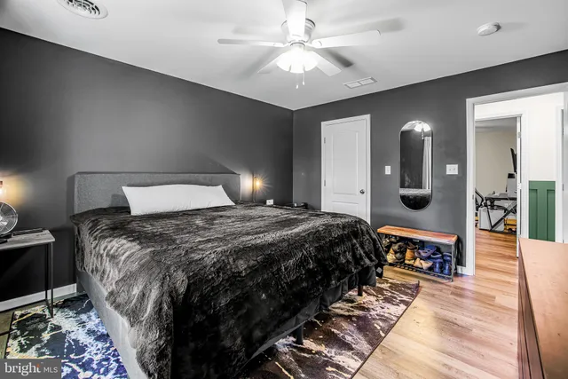 a bedroom with a large bed and a chandelier