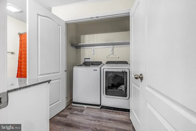 a utility room with sink dryer and washer
