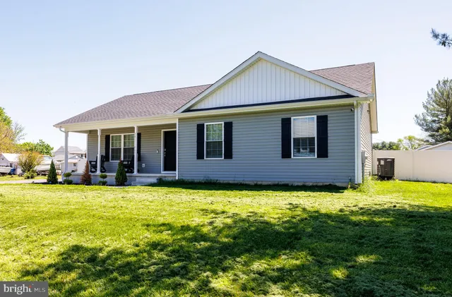 a view of a house with a swimming pool and a yard