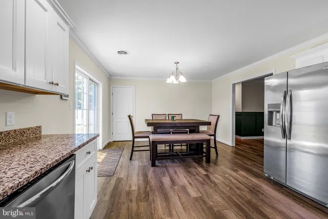 a kitchen with a table and chairs in it