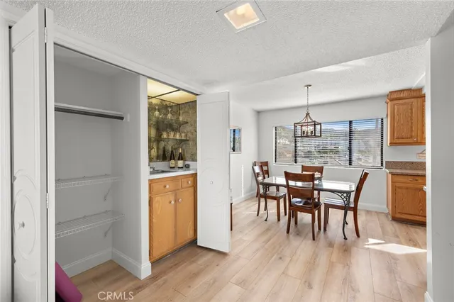 a kitchen with a dining table chairs stainless steel appliances and cabinets