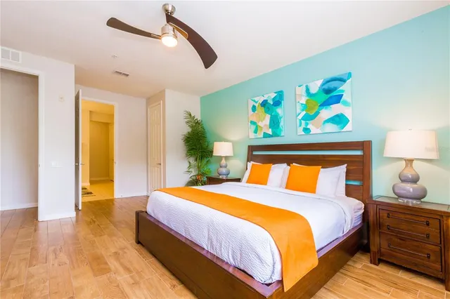 a bedroom with a bed and wooden floor