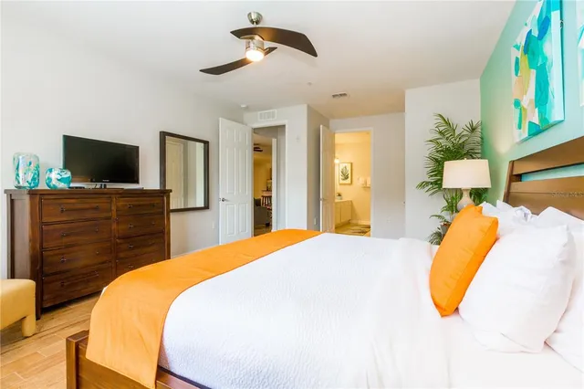 a bedroom with a bed and a flat screen tv