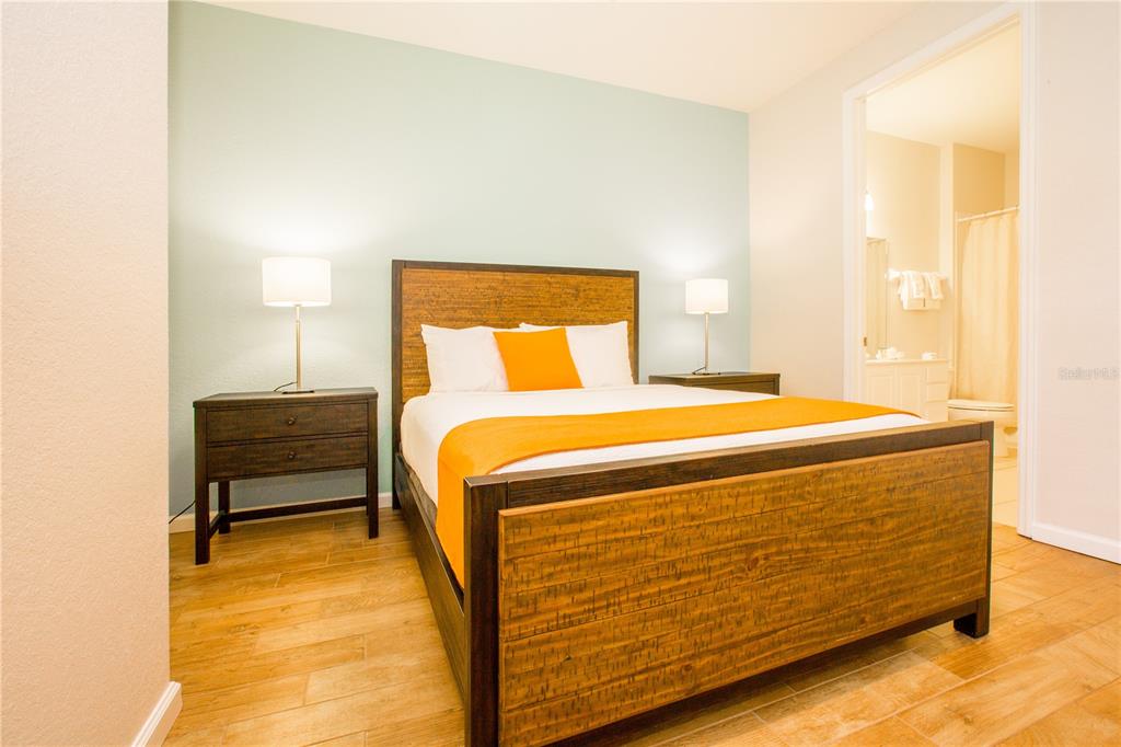 5025 Shoreway Loop, Unit 105 Orlando, FL 32819 - Photo 17 of 55 a bedroom with a bed and a night stand