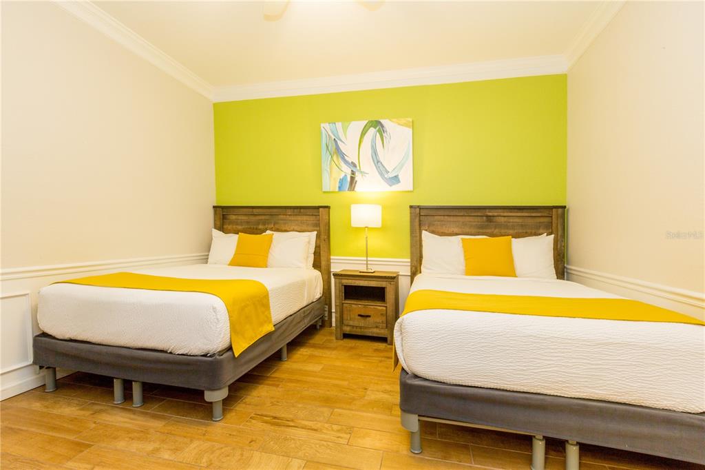 5025 Shoreway Loop, Unit 105 Orlando, FL 32819 - Photo 19 of 55 a bedroom with a bed and wooden floor