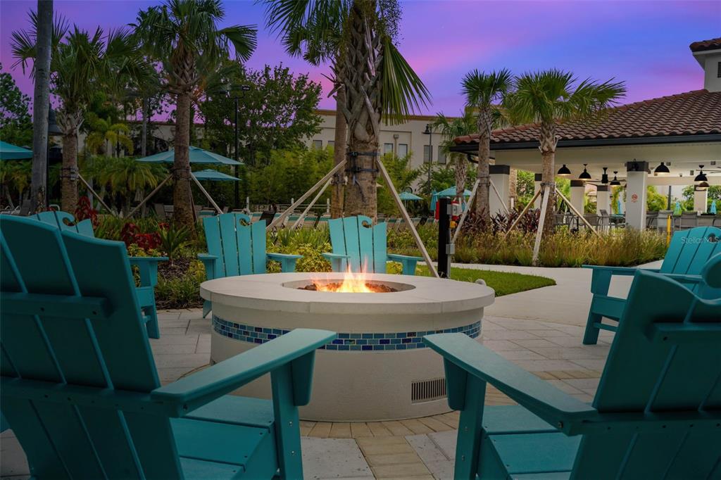5025 Shoreway Loop, Unit 105 Orlando, FL 32819 - Photo 48 of 55 a view of a wooden chairs and table in patio