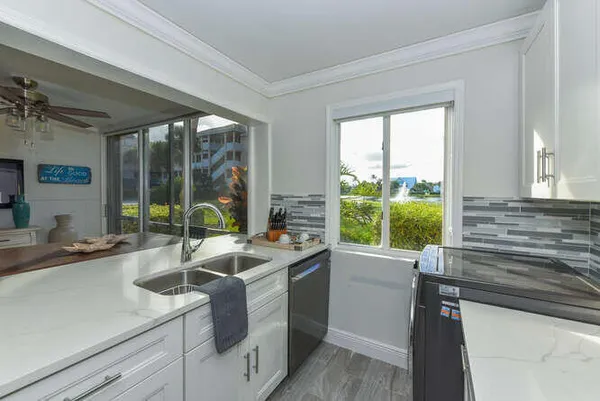 a kitchen with a sink and a large window