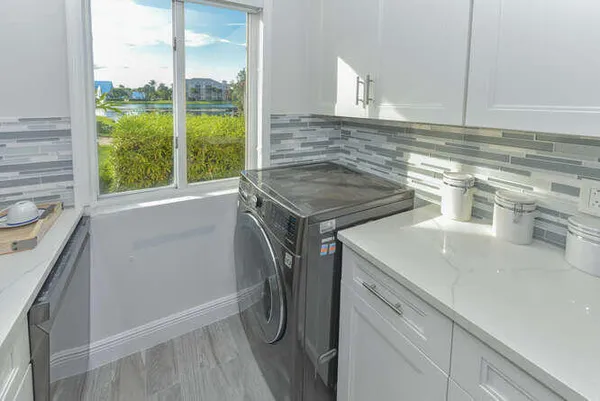 a utility room with a sink dryer and washer