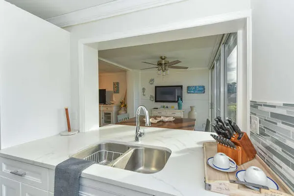 a kitchen with a sink and a mirror