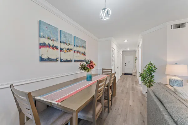 a view of a dining room with furniture and wooden floor