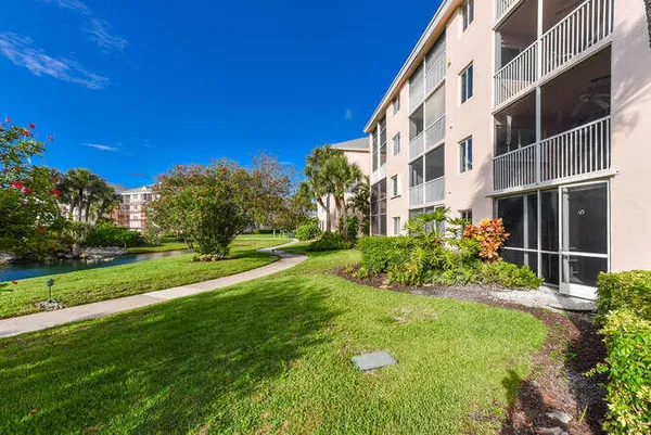a view of an apartment building and a yard