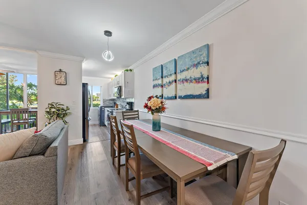 a dining room with furniture and wooden floor