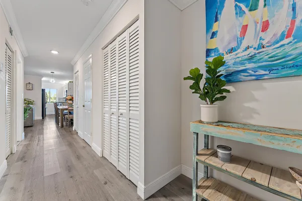a hallway with a table and a potted plant
