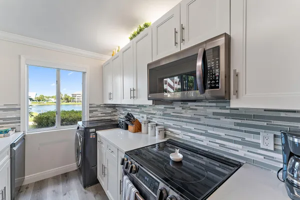 a kitchen with a stove a sink and a microwave