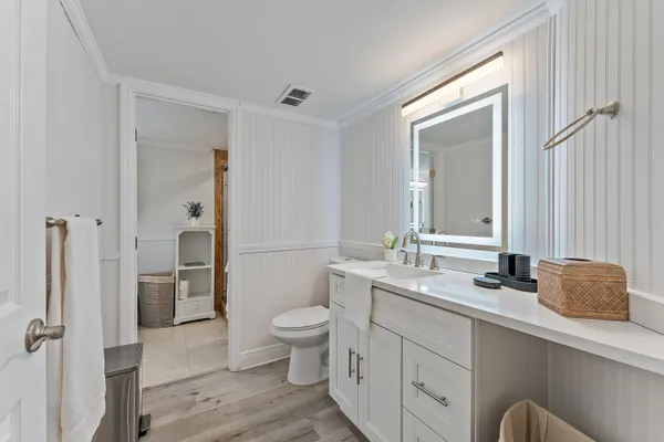 a bathroom with a double vanity sink toilet and shower