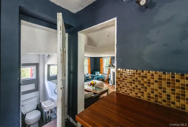 a living room with furniture a fireplace and a floor to ceiling window