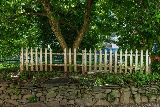 a backyard of a house with lots of green space and fountain