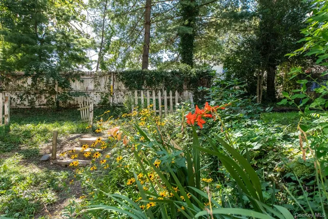 a view of a house with a yard and wooden fence