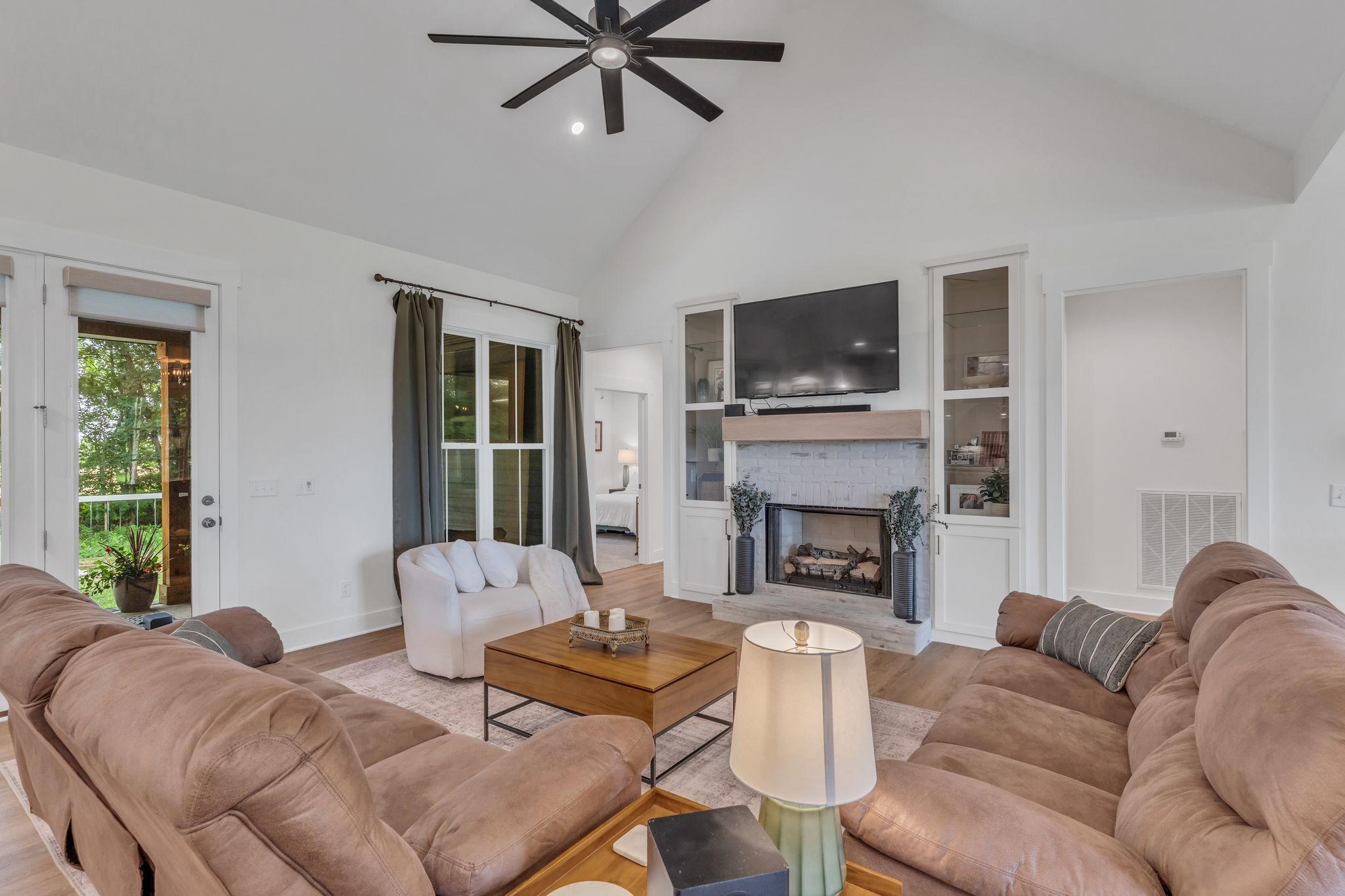 8921 Cedar Grove Road Cross Plains, TN 37049 - Photo 12 of 50 a living room with furniture a flat screen tv and a fireplace