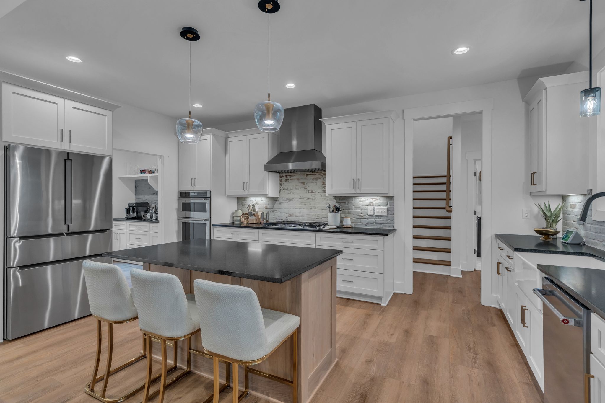 8921 Cedar Grove Road Cross Plains, TN 37049 - Photo 16 of 50 a kitchen with granite countertop a refrigerator a stove a sink and white cabinets