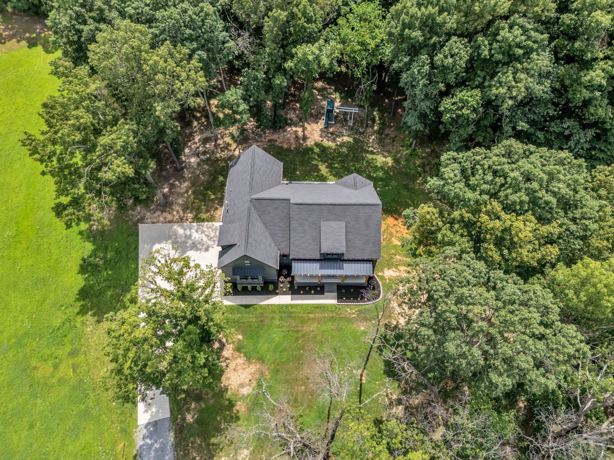 8921 Cedar Grove Road Cross Plains, TN 37049 - Photo 5 of 50 a backyard of a house with table and chairs and wooden fence