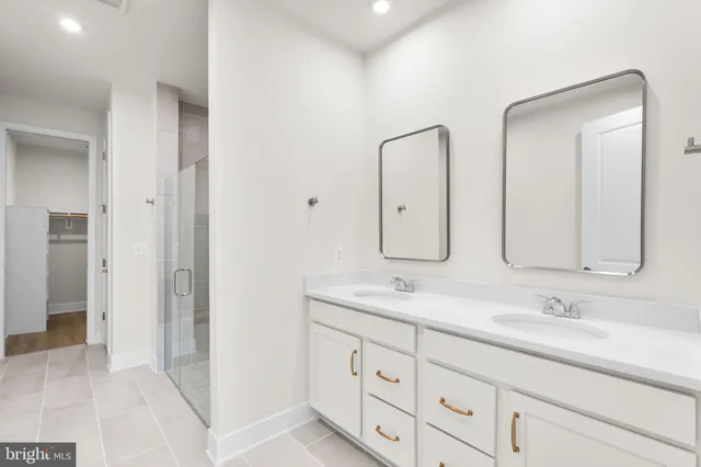 a bathroom with double sink and a mirror