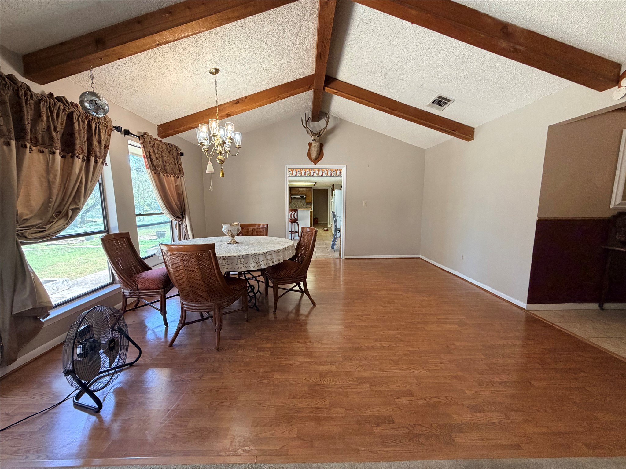 2800 Robin Road Manchaca, TX 78652 - Photo 9 of 28 Gleaming wood floors complement the vaulted ceiling with rustic exposed beams in this spacious area.