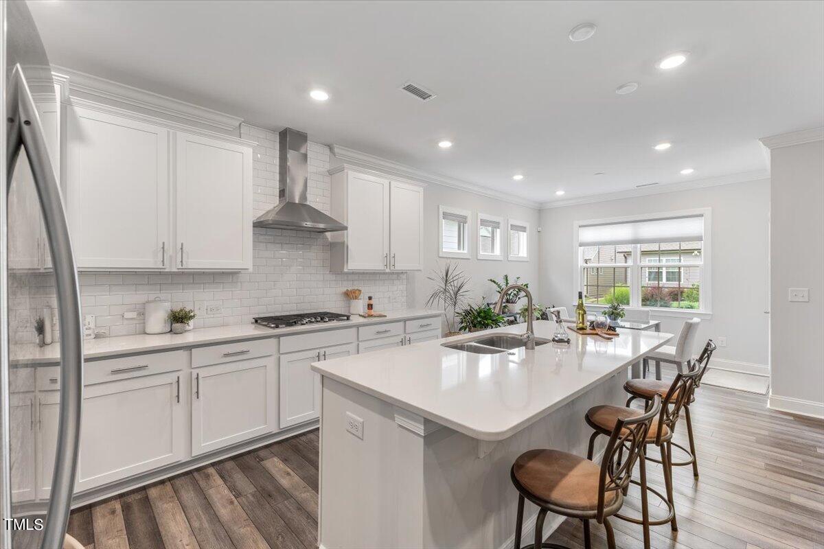 213 Mahogany Run Raleigh, NC 27610 - Photo 13 of 40 a kitchen with stainless steel appliances white cabinets a table and chairs in it