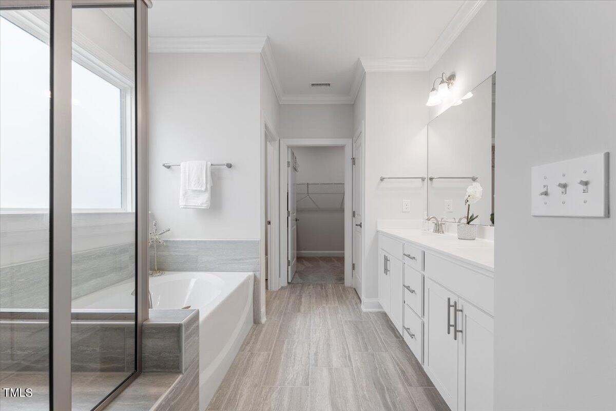 213 Mahogany Run Raleigh, NC 27610 - Photo 23 of 40 a spacious bathroom with a double vanity sink a mirror and a shower