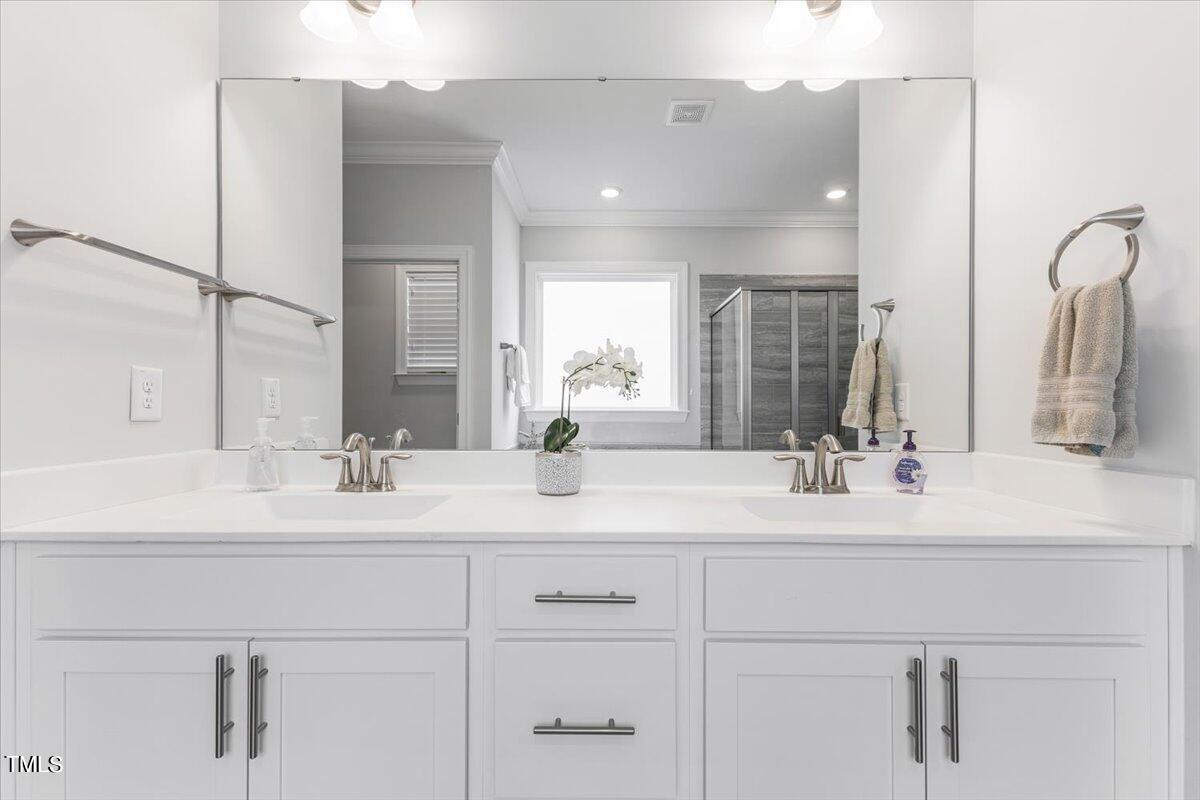 213 Mahogany Run Raleigh, NC 27610 - Photo 24 of 40 a bathroom with double sink and a mirror