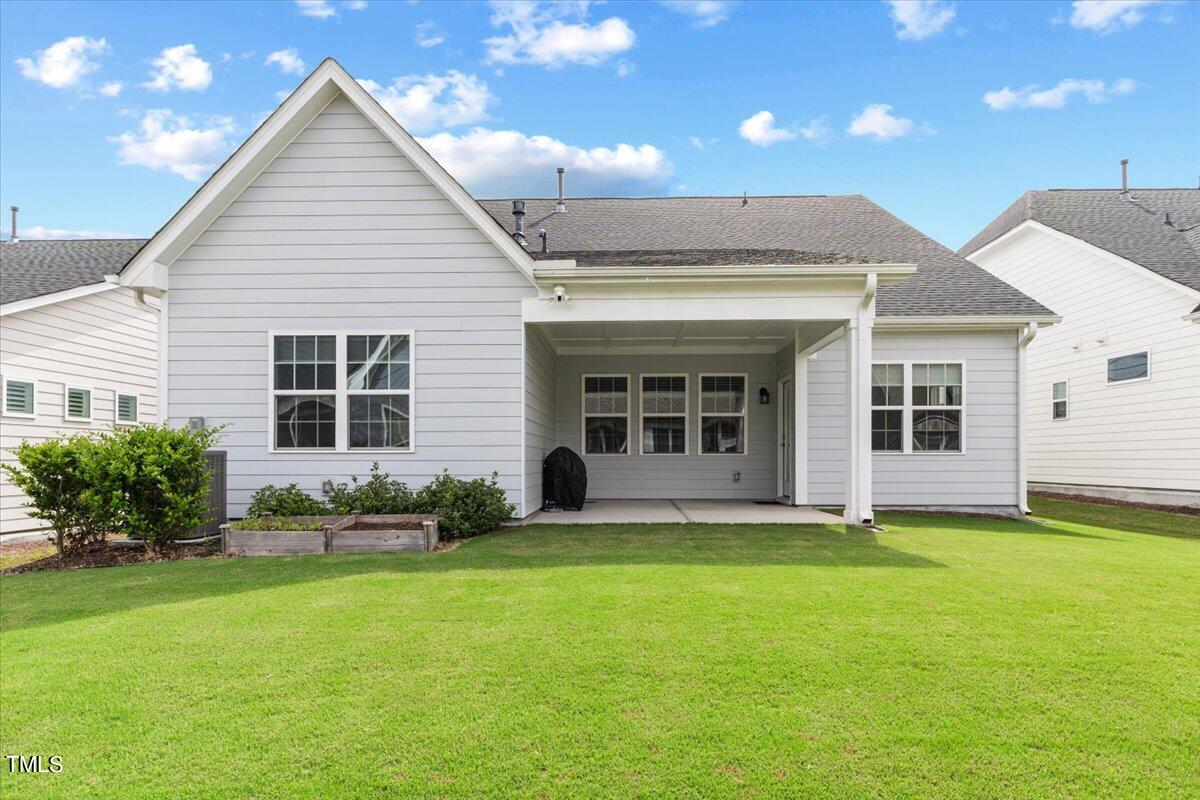 213 Mahogany Run Raleigh, NC 27610 - Photo 30 of 40 a front view of a house with a garden and porch