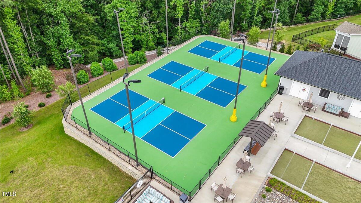 213 Mahogany Run Raleigh, NC 27610 - Photo 36 of 40 a aerial view of a tennis ground with large trees
