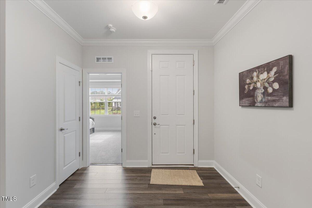 213 Mahogany Run Raleigh, NC 27610 - Photo 4 of 40 wooden floor in a hall with an empty room
