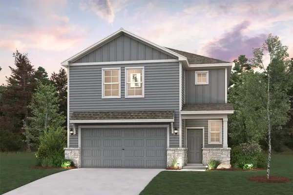 a front view of a house with a garden and garage