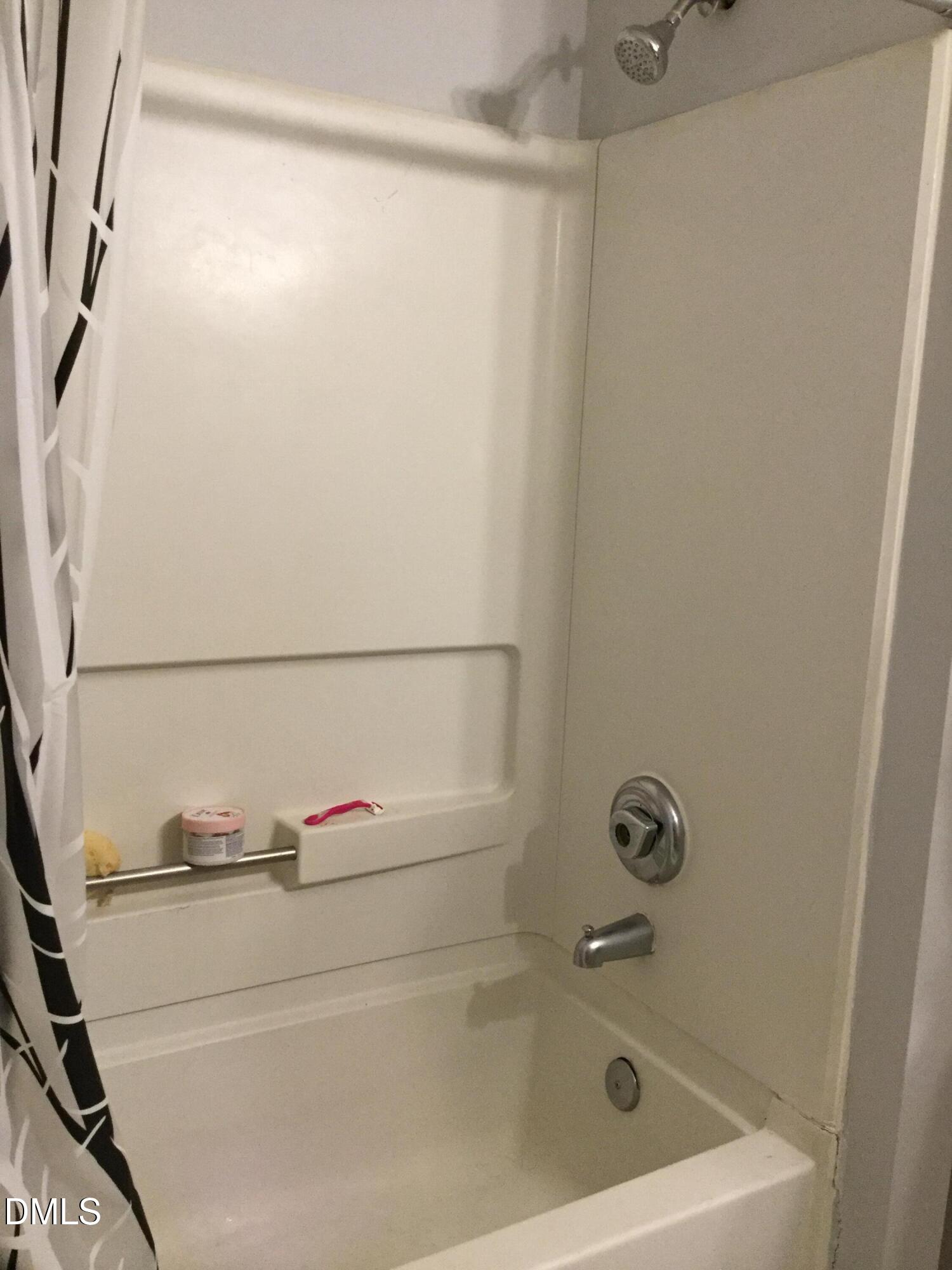 1110 Carlton Avenue, Unit 204 Raleigh, NC 27606 - Photo 6 of 12 a bathroom with a tub and a shower