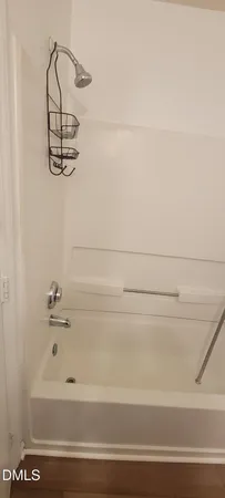 a bathroom with a tub and a shower