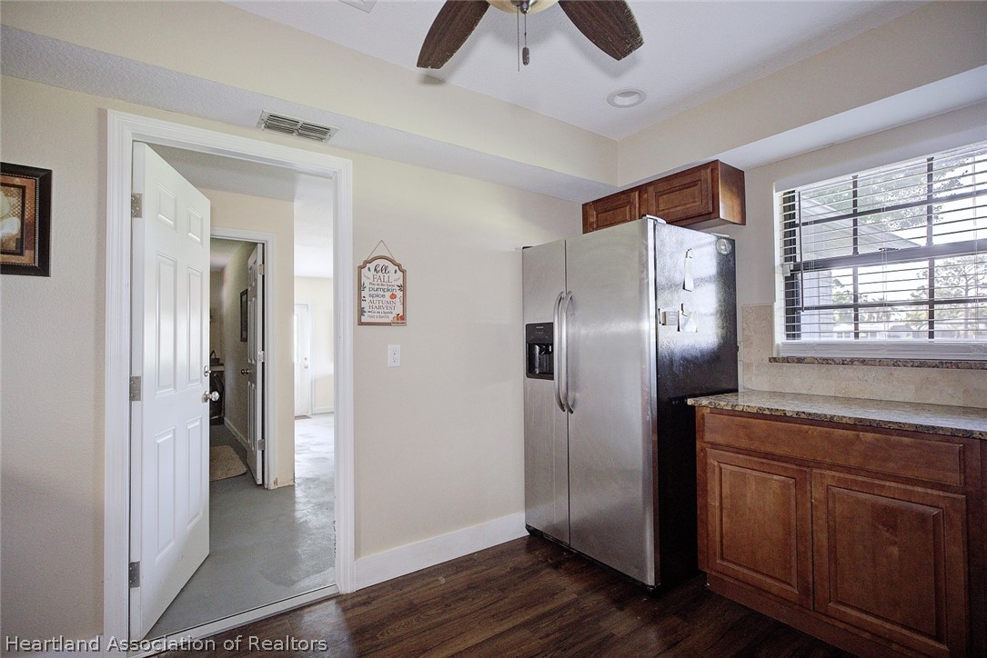 3601 Divot Road Sebring, FL 33872 - Photo 13 of 31 a kitchen with stainless steel appliances granite countertop a refrigerator and a sink