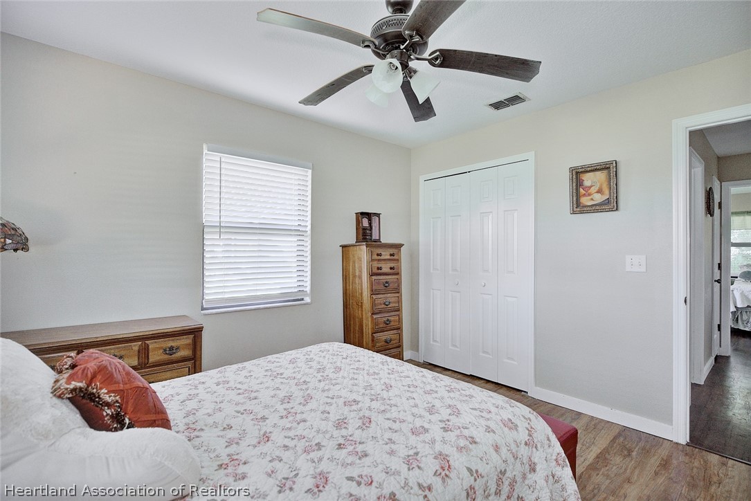 3601 Divot Road Sebring, FL 33872 - Photo 27 of 31 a bedroom with a large bed and a window