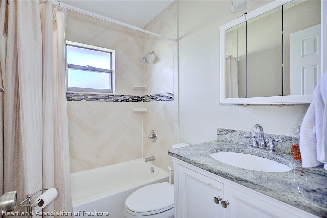 3601 Divot Road Sebring, FL 33872 - Photo 29 of 31 a bathroom with a granite countertop sink toilet and shower