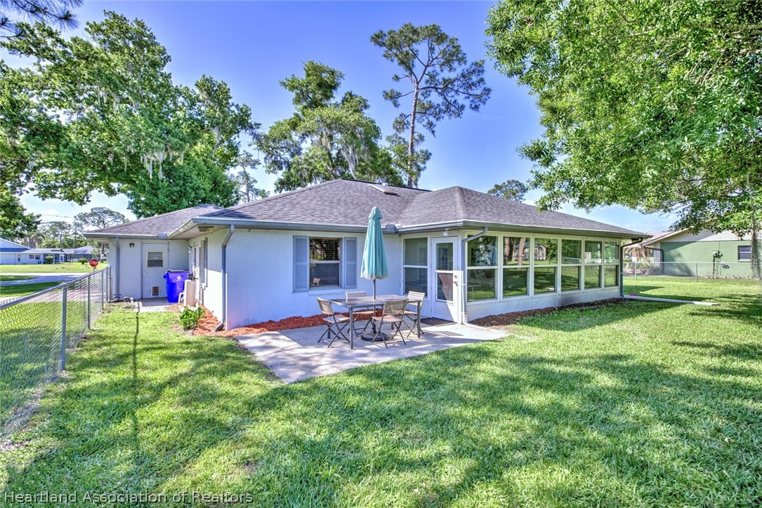 3601 Divot Road Sebring, FL 33872 - Photo 7 of 31 a front view of a house with a garden and patio
