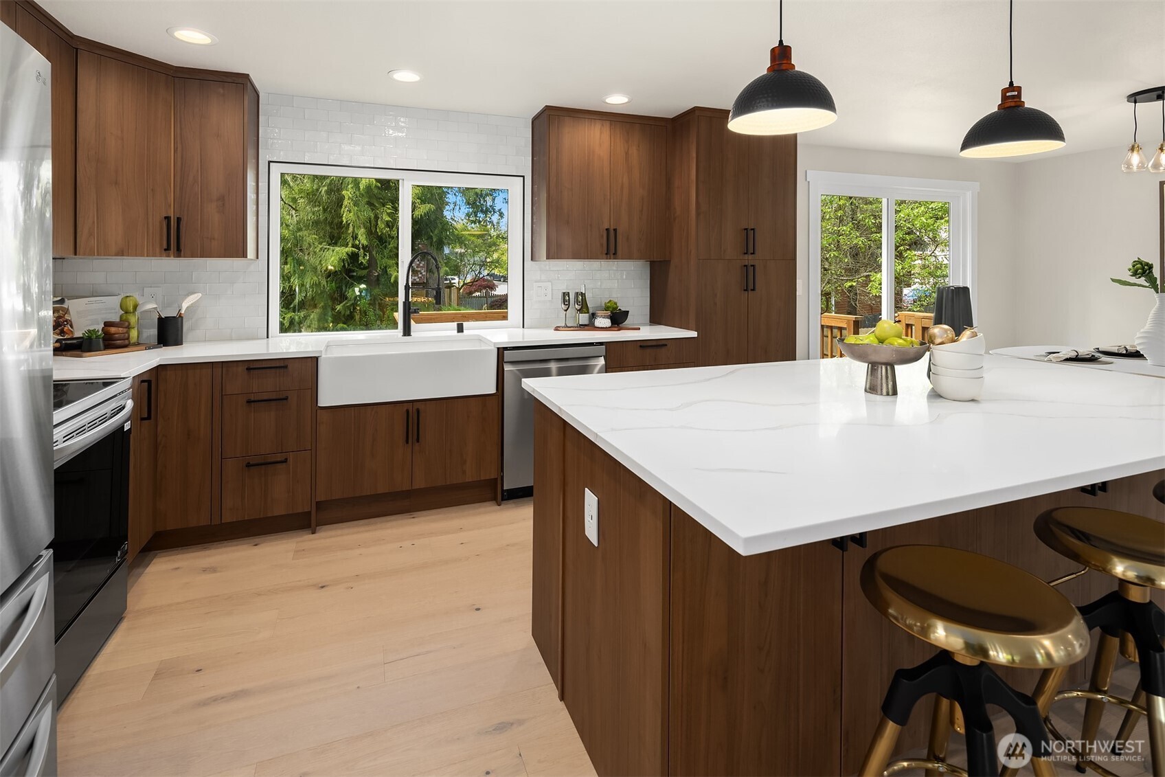 16914 28th Drive Southeast Bothell, WA 98012 - Photo 5 of 30 a kitchen with a stove a sink a kitchen island with wooden cabinets and stainless steel appliances