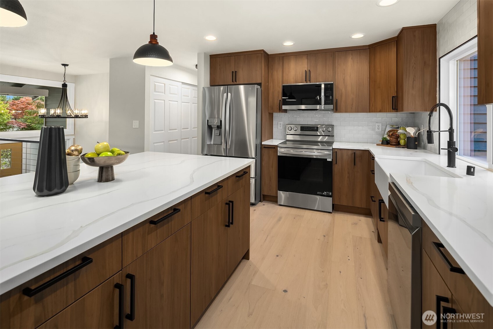 16914 28th Drive Southeast Bothell, WA 98012 - Photo 7 of 30 a kitchen with kitchen island a refrigerator a sink a stove and cabinets