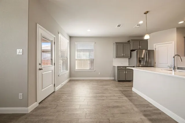 a kitchen with stainless steel appliances a refrigerator and a sink