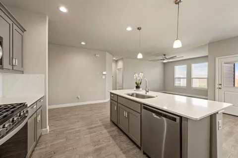 a kitchen with sink and stove