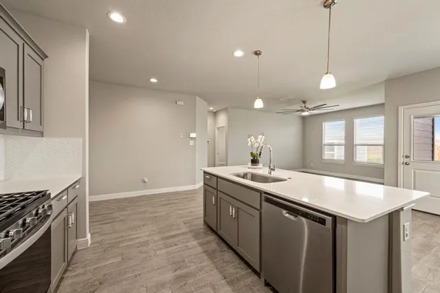 a kitchen with sink and stove