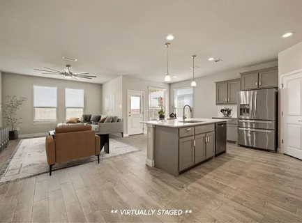 a large white kitchen with cabinets a sink and appliances