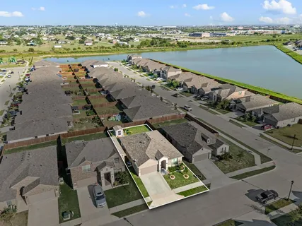 an aerial view of a city with lots of residential buildings and lake view