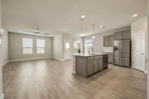 a large kitchen with a lot of counter space and stainless steel appliances