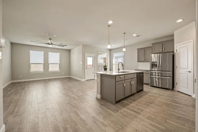 a large kitchen with a lot of counter space and stainless steel appliances